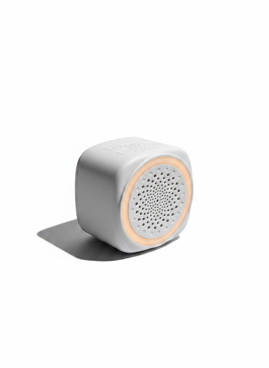 Vamos Niños máquina de sonido portátil gris con luz ambiental personalizable, ideal para bebés y relajación.