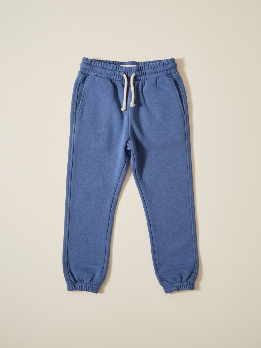 Pantalón de buzo unisex Vamos Niños Lefties en color celeste claro con cintura elástica y cordón ajustable