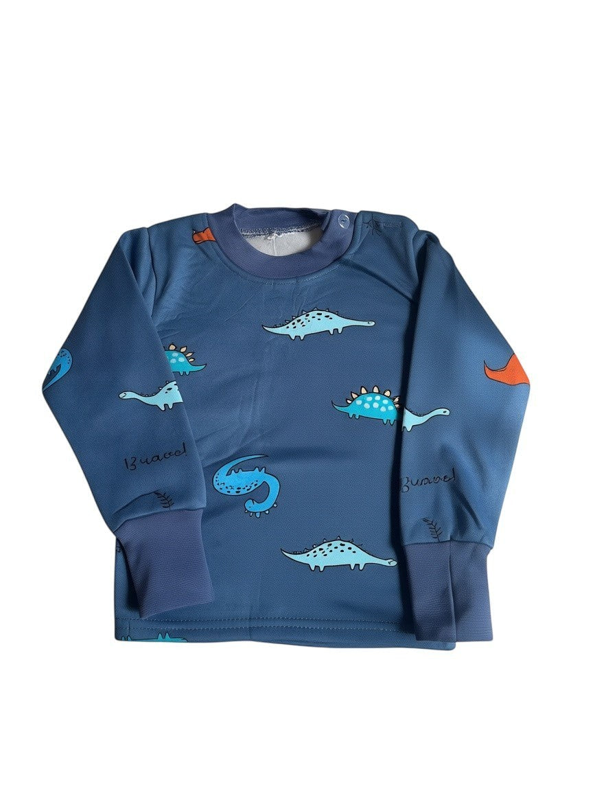 Pijama afranelado Vamos Niños azul con estampado de dinosaurios, manga larga y puños elásticos para mayor comodidad.