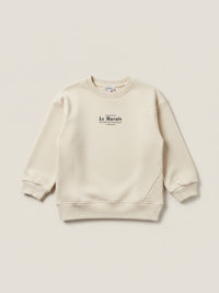 Polerón beige de niña Vamos Niños marca Lefties con estampado de letras negras en el pecho y cuello redondo