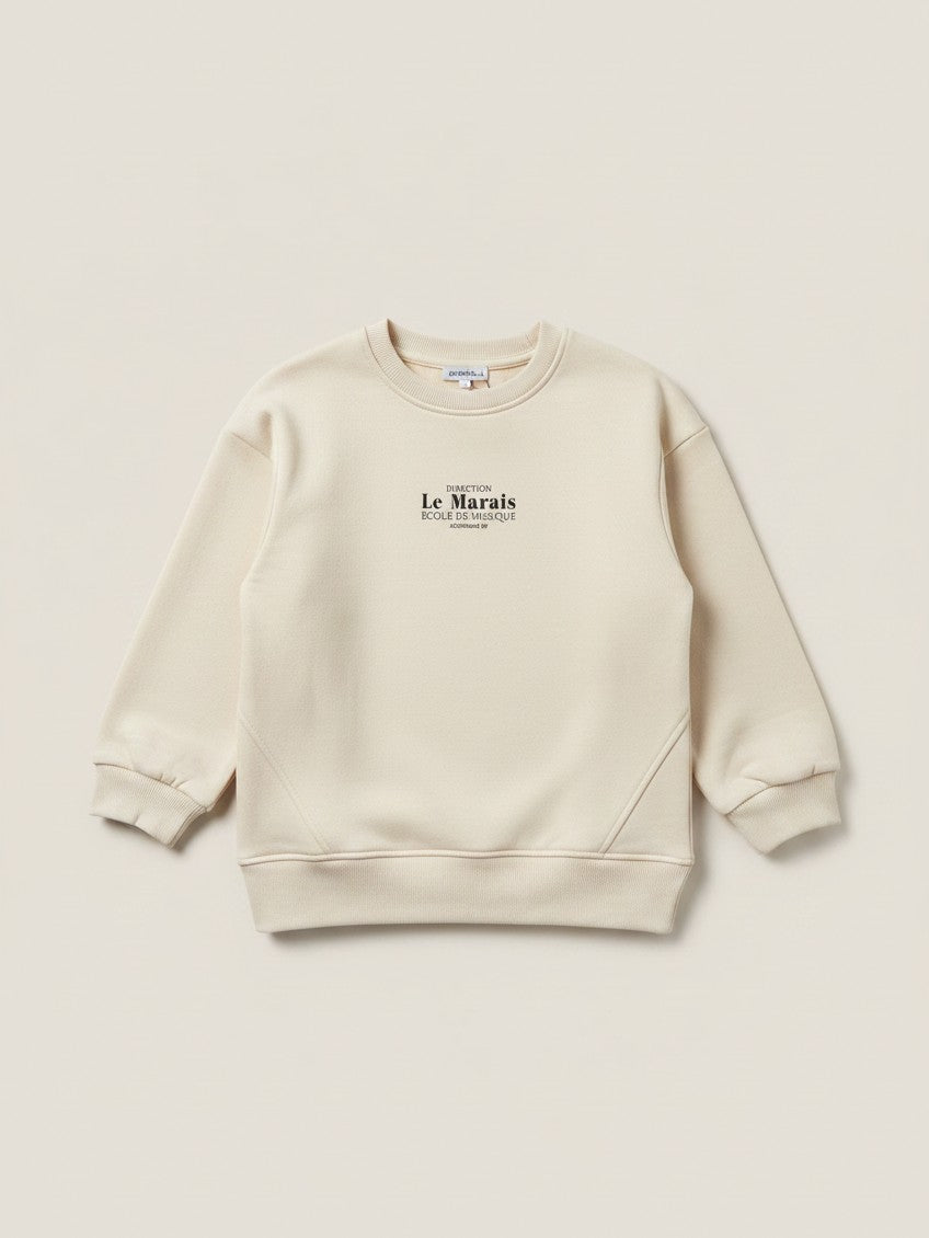 Polerón beige de niña Vamos Niños marca Lefties con estampado de letras negras en el pecho y cuello redondo
