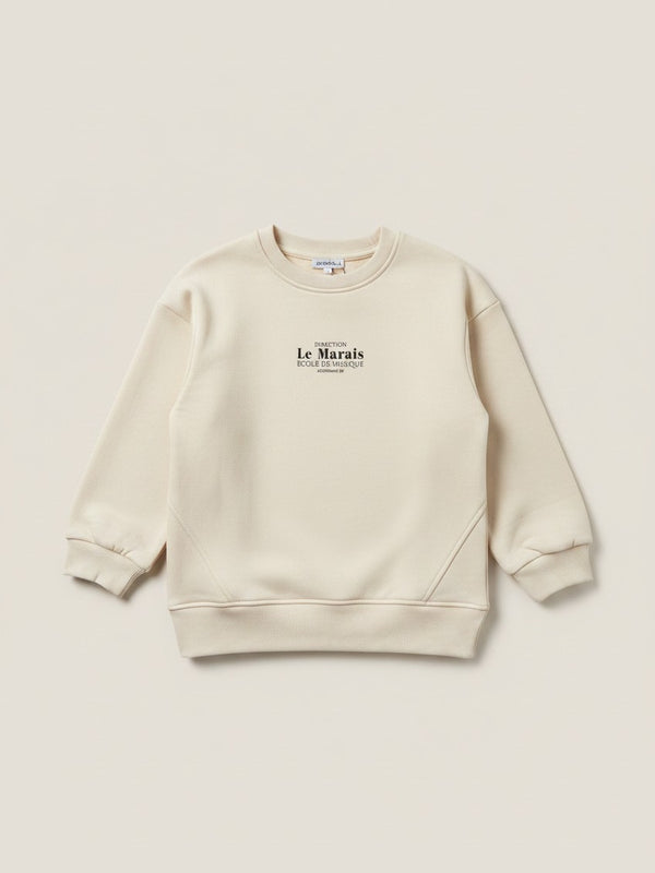 Polerón beige de niña Vamos Niños marca Lefties con estampado de letras negras en el pecho y cuello redondo