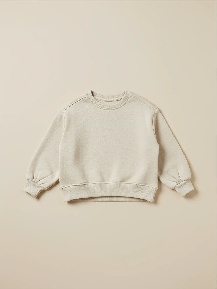 Polerón beige de niña marca Vamos Niños con cuello redondo y mangas abullonadas, estilo casual y cómodo.