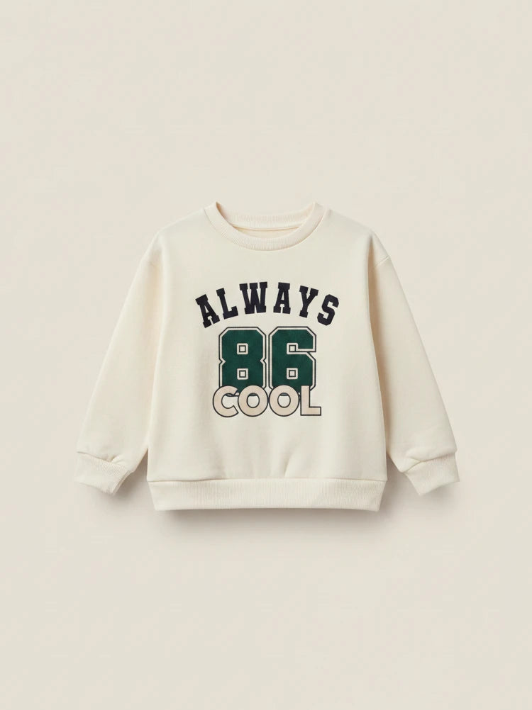 Polerón beige de Vamos Niños Lefties para bebé con estampado universitario verde y texto Always Cool