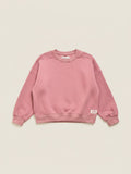 Polerón de niña color rosado viejo de la marca Vamos Niños, diseño de cuello redondo y corte holgado.