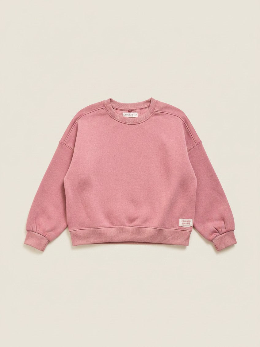 Polerón de niña color rosado viejo de la marca Vamos Niños, diseño de cuello redondo y corte holgado.