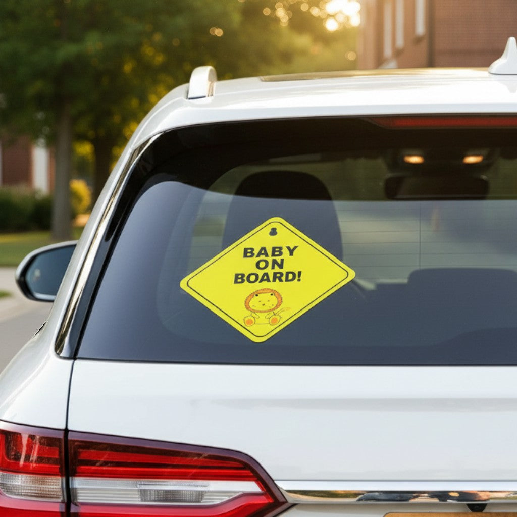 Cartel de seguridad Vamos Niños amarillo con diseño de león y texto Baby on Board pegado en la luneta de un coche.